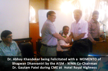 Dr. Abhay Khandekar being Felicitated with a  MOMENTO of  Bhagwan Dhanvantri by the AISM - NIMA Co-Chairman Dr. Gautam Patel during CME at  Hotel Royal Highness