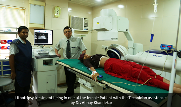 Lithotripsy treatment being in one of the female Patient with the Technician assistance  by Dr. Abhay Khandekar