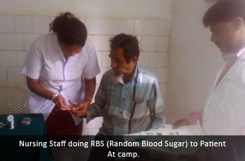 Nursing Staff doing RBS (Random Blood Sugar) to Patient at camp.